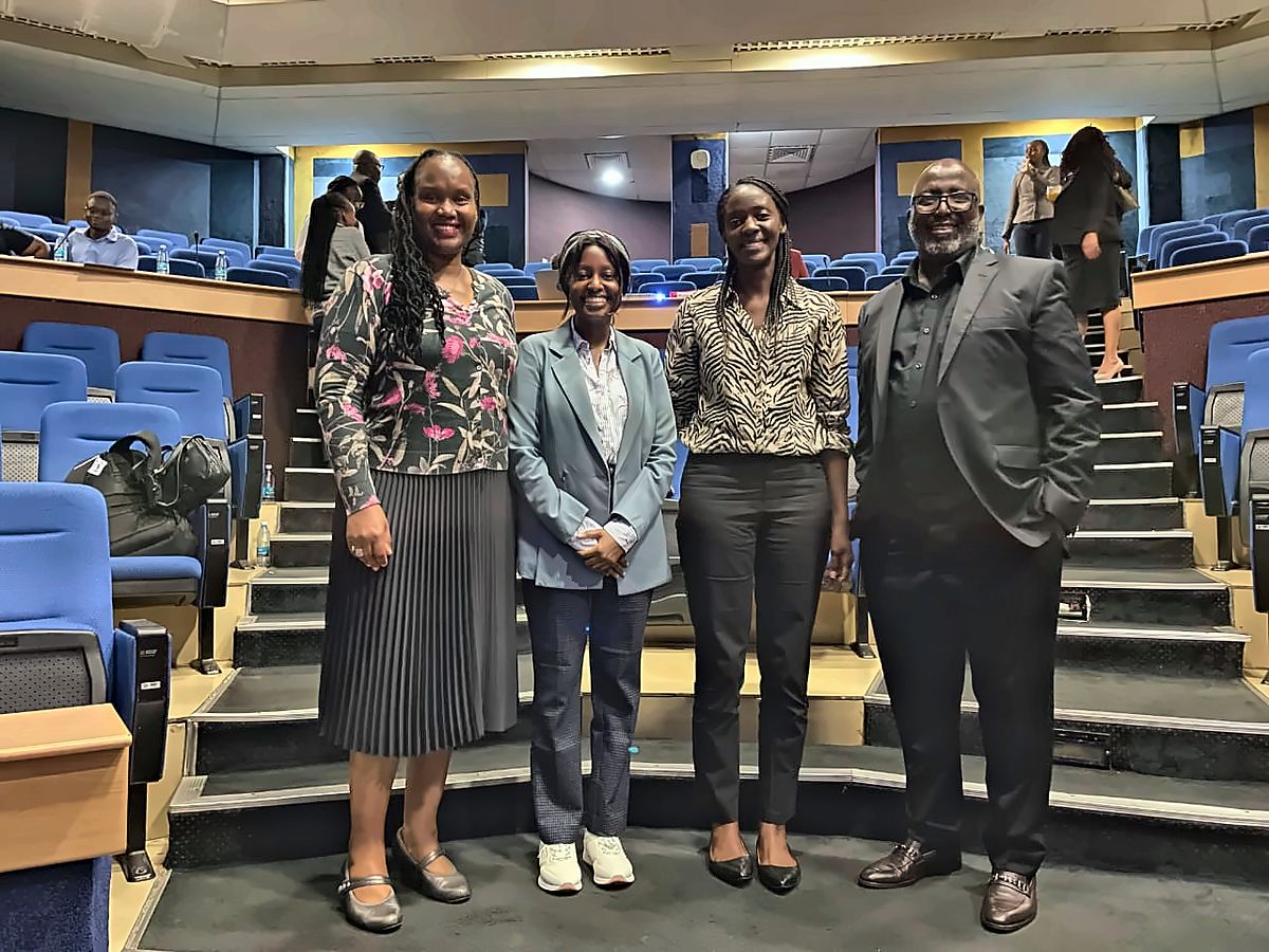 Four people in a lecture theatre after an advocacy and policy meeting