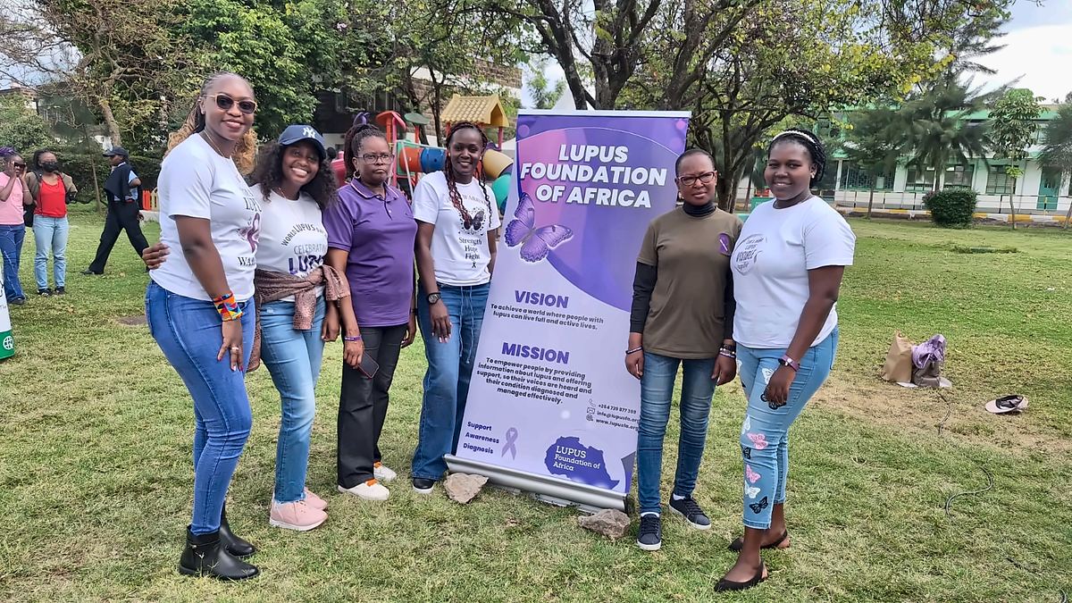 LFA members beside the Lupus Foundation of Africa banner at the Lupus Wellness & Rheumatology Camp 2025