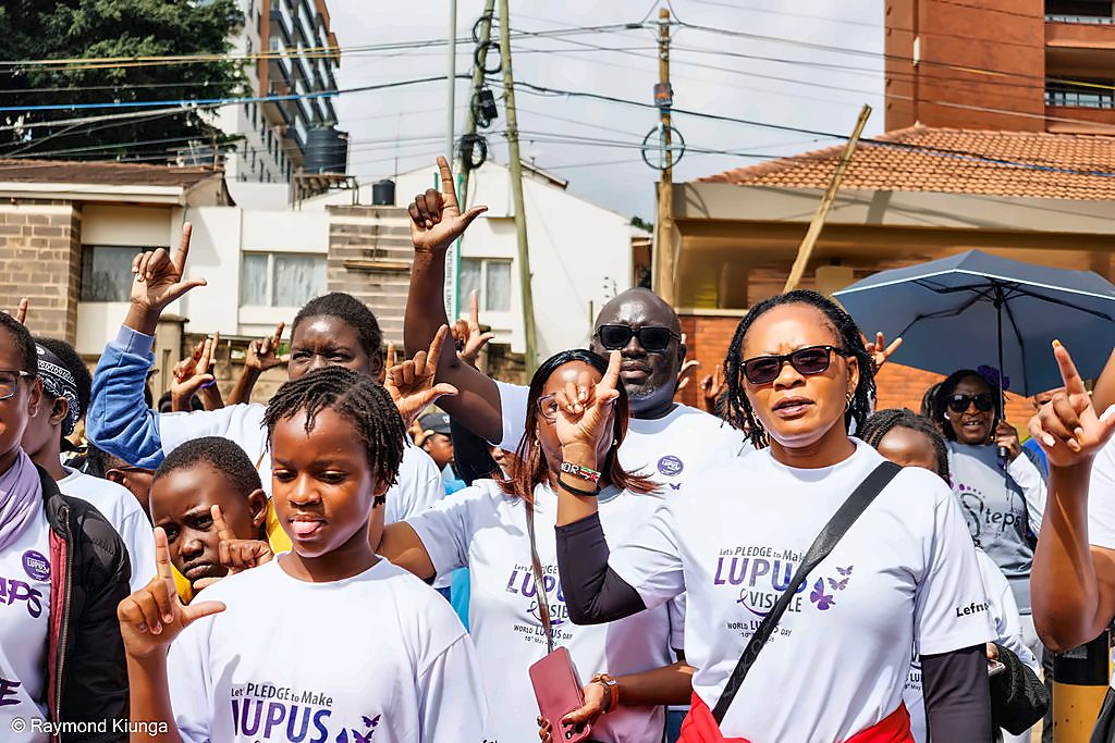 LFA community members raising their hands together at World Lupus Day 2026