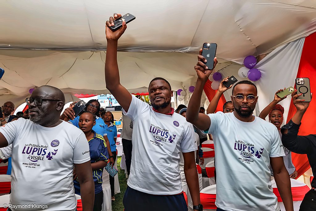 Attendees raising their phones to capture the moment