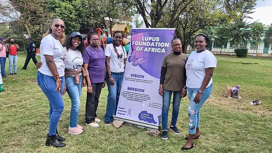 LFA members beside the Lupus Foundation of Africa banner at the Lupus Wellness & Rheumatology Camp 2025