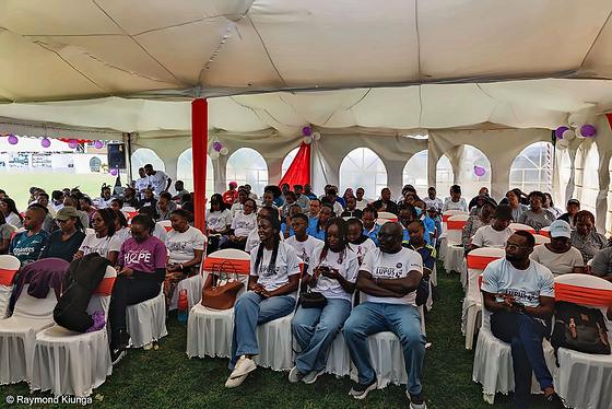The community seated under the tent for the World Lupus Day programme