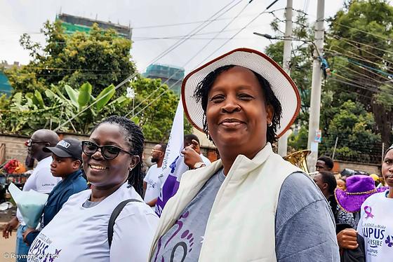 A walker in a white hat smiling during the community walk