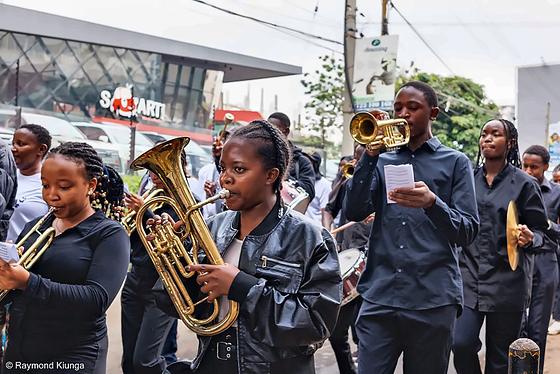 Young musicians in the brass band playing on the walk route