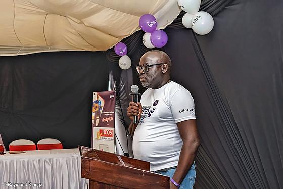 A speaker at the lectern addressing the community