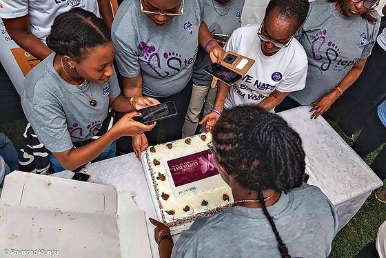 Members gathering round to photograph the World Lupus Day cake