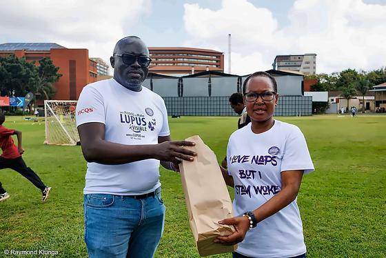 A gift of thanks changing hands at the partner recognition