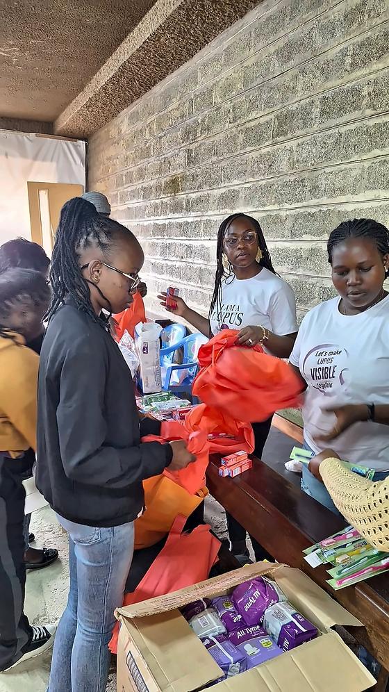 Packing donated toiletries and sanitary pads into bags during a KNH rheumatology ward visit