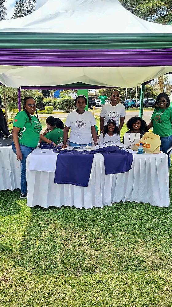 LFA members at their stand under a purple and green tent at the Mater Open Day