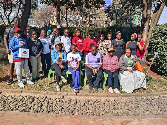 A group photograph of the LFA community meetup in a garden